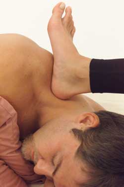 Fix Pain photo of barefoot therapy on upper trapezius