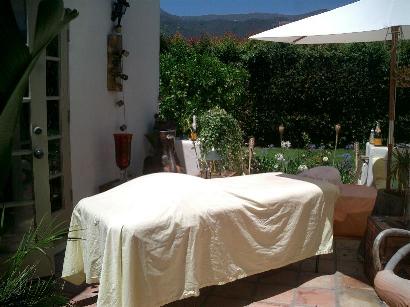 Massage outside on a table with sheets